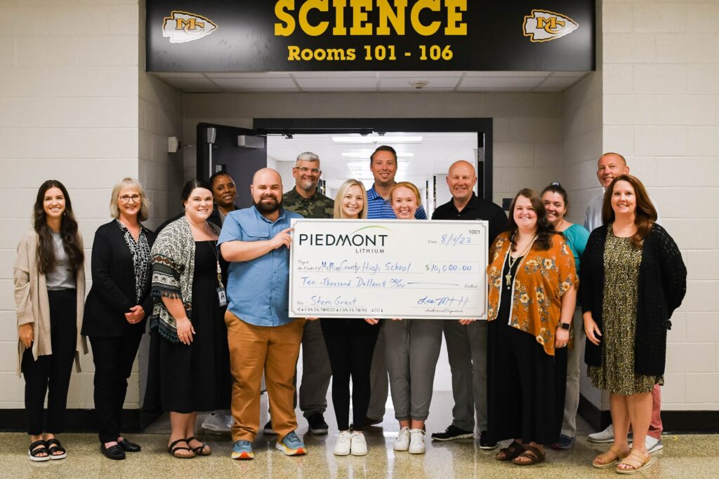 photo of donation check being held by McMinn County High School staff
